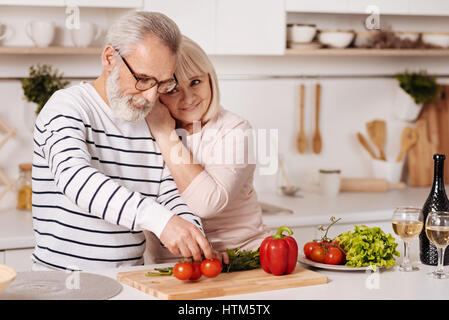 Cute elderly couple preparing family dinner in the kitchen Stock Photo