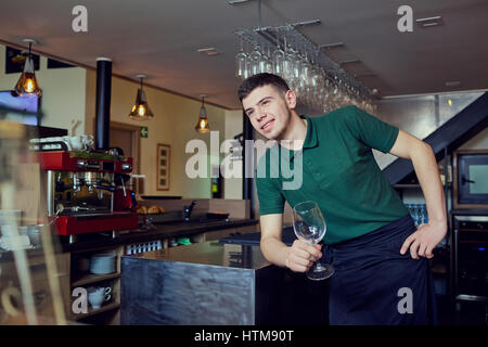 A guy is barista barista waiter at  bar cafe restaurant in the workplace. Stock Photo