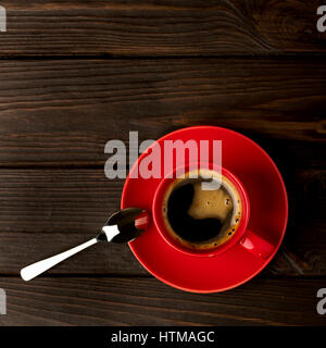 Red cup of coffee on dark wooden background. Selective focus. Stock Photo