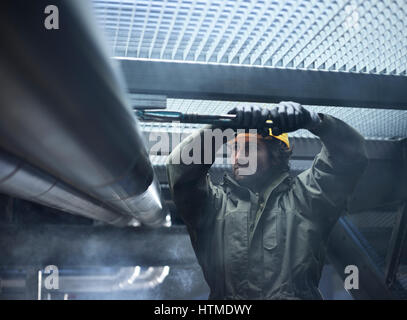 Mechanic, technician fixing mount of a pipeline, Austria Stock Photo