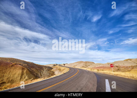 Beautiful cloudscape and highway with a stop sign, USA. Stock Photo