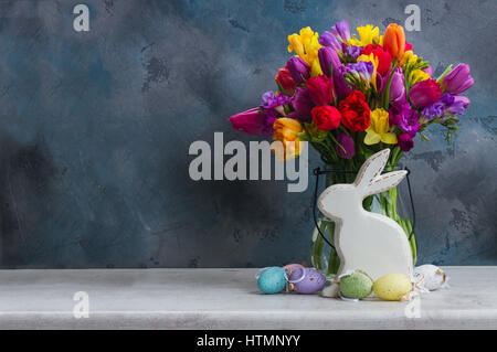 Spring flowers with easter rabbit and eggs Stock Photo