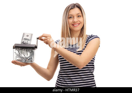 Happy woman destroying a dollar banknote in a paper shredder isolated on white background Stock Photo