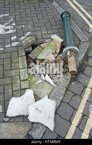 uprooted bollard on a street with cycle markings and double yellow lines, in twickenham, middlesex, england Stock Photo