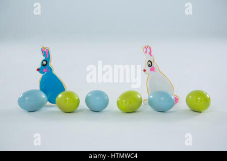 Easter eggs with toy Easter bunny on white background Stock Photo