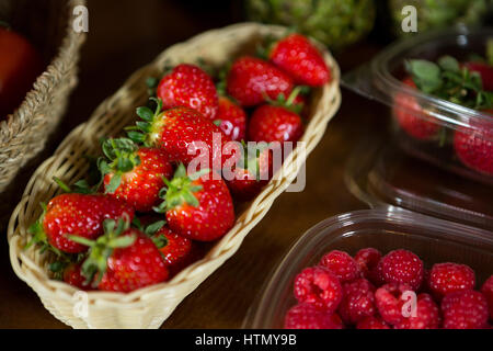 Close-up of small wicker basket full of strawberry at organic section in market Stock Photo
