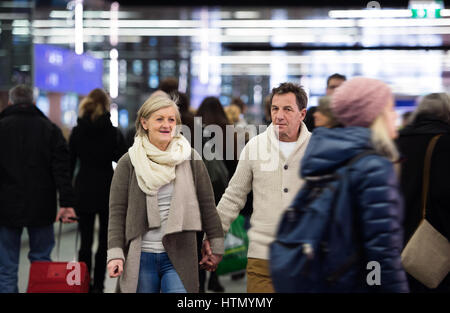 Senior couple standing in hallway of subway, holding hands. Stock Photo