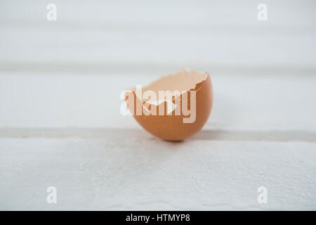 Close-up of broken Easter egg on wooden surface Stock Photo
