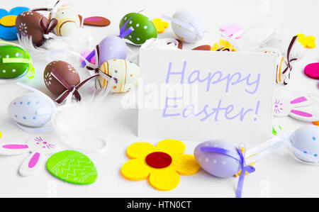 Happy Easter tag with easter eggs, flowers, bunnies and feathers decorations Stock Photo