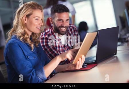 Programmers and business people collaborating in company office Stock Photo