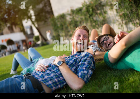 Happy young people on ground smiling and having fun Stock Photo