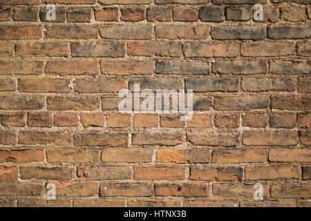 Old red brick wall showing signs of age and decay. Stock Photo