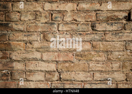A very old red brick wall texture with missing morter and cracks. Stock Photo