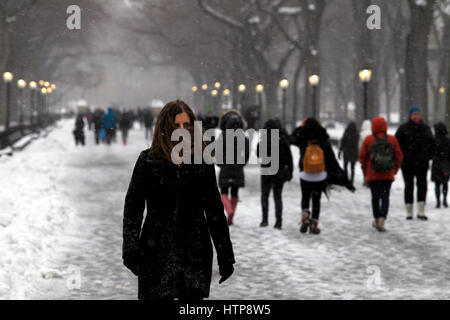 New York, United States. 14th Mar, 2017. People walk through New York City's Central Park during a snowstorm on March 14, 2017, which was predicted to bring as much as two feet of snow to the city but only brought 7 inches. Schools closed and the city was relatively quiet as many stayed home but some ventured out to enjoy themselves in the park. Credit: Adam Stoltman/Alamy Live News Stock Photo