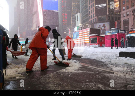 Times Square Alliance workers shovel snow in Times Square during Winter Storm Stella in Times Square. Stock Photo