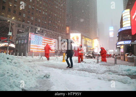 Times Square Alliance workers shovel snow in Times Square during Winter Storm Stella in Times Square. Stock Photo