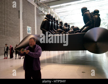 Prague, Czech Republic. 16th Mar, 2017. Chinese conceptual artist Ai Weiwei showing his installation with of a 70 meter long rubber boat with 280 larger-than-life figures of refugees hanging from the ceiling of the National Gallery in Prague, Czech Republic, 16 March 2017. With this work the artist deals with the refugee crisis. - NO WIRE SERVICE- Photo: Michael Heitmann/dpa/Alamy Live News Stock Photo