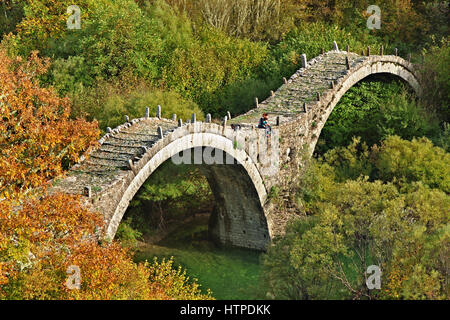 A stone bridge called Kalogeriko, or 'the bridge of the monk', in the mountainous region of Zagori, in Epirus, northern Greece. Stock Photo