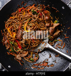Stir fry soba noodles with beef and vegetables in wok pan close up Stock Photo