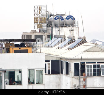 Solar hot water heaters with holding tanks installed on rooftop,  Boss Legend Hotel, high rise. Stock Photo