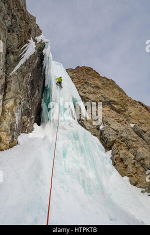 Elijah Weber climbs a route called Preacher rated WI5 near Sun Valley Idaho Stock Photo