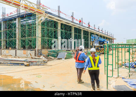 Construction site Team or Women worker with helmets discuss at a scaffolding construction, form work and structure at the construction site Stock Photo