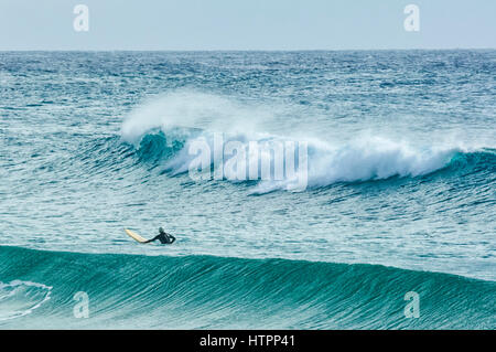 A surfer waits for the perfect wave, Dalmeny, South Coast, New South Wales, NSW, Australia Stock Photo