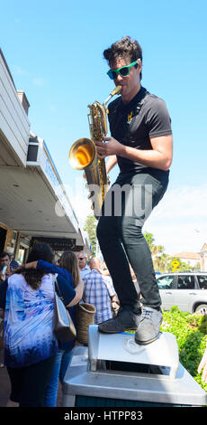 The saxophonist member of the Hot Potato group performs perched on a bin at Kiama Jazz & Blues Festival 2017, Illawarra Coast, New South Wales, NSW, A Stock Photo