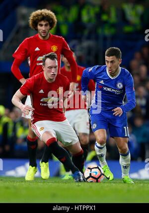 Eden Hazard of Chelsea breaks away from Phil Jones of Manchester United as Marouane Fellaini looks on during the FA Cup match between Chelsea and Manchester United at Stamford Bridge in London. March 13, 2017. *** EDITORIAL USE ONLY *** FA Premier League and Football League images are subject to DataCo Licence see www.football-dataco.com James Boardman / Telephoto Images +44 7967 642437 Stock Photo