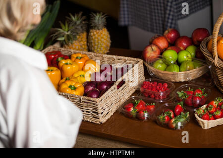 Various types of fruits and vegetables at counter in market Stock Photo
