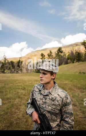 Military soldier guarding with a rifle in a boot camp Stock Photo