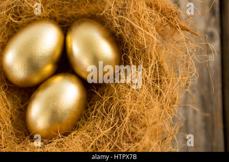 Close-up of golden Easter eggs in the nest Stock Photo