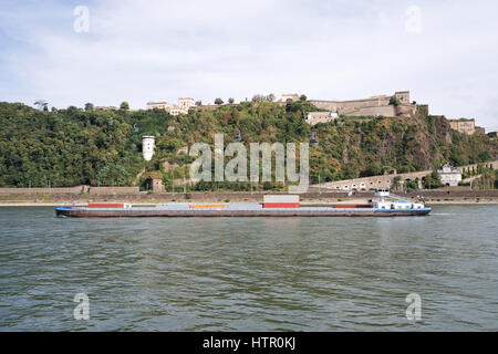 inland container vessel passing fortress Ehrenbreitstein in Koblenz/ Germany Stock Photo