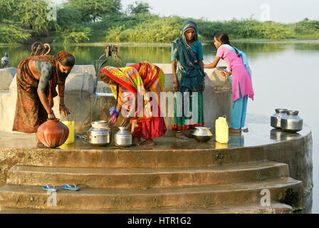 Women draw water from a Mir village well near Dasada, Gujarat, India Stock Photo