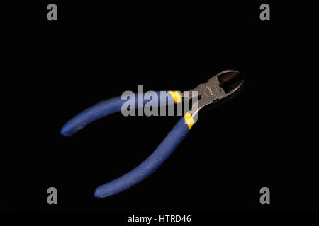 Blue side cutter pliers on a back background Stock Photo