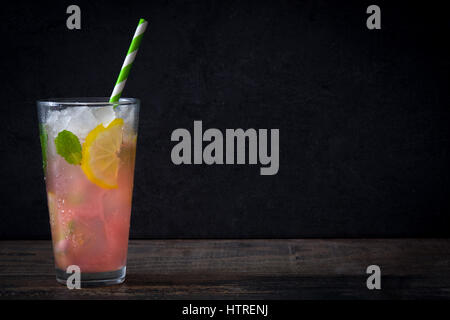 Fresh watermelon mojito on a rustic wooden table and black background Stock Photo
