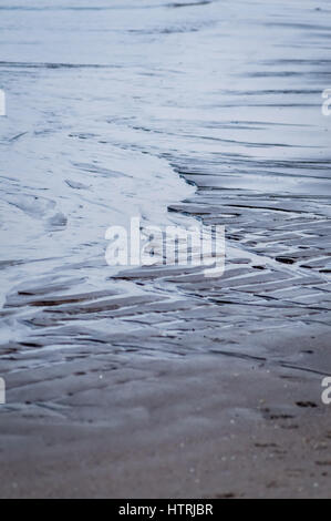 wet rippled sand and water at the beach abstract background, Adriatic sea in Italy Stock Photo