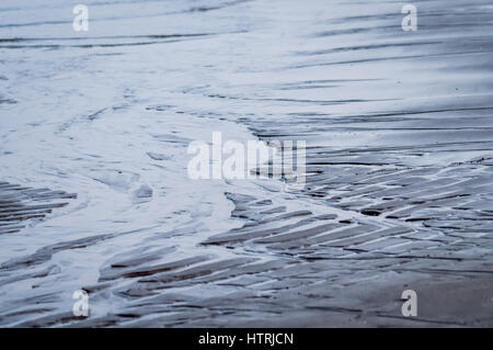 wet rippled sand and water at the beach abstract background, Adriatic sea in Italy Stock Photo