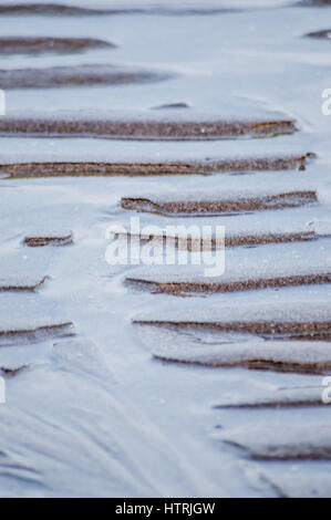 Rippled wet sand and water at the beach texture background, Adriatic sea in Italy Stock Photo