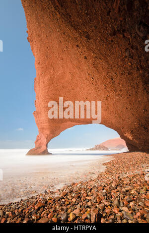 Red arches and rocky beach at the Atlantic Ocean in the region Sous-Massa-Draa, Sidi Ifni, Legzira, Morocco, Africa. Stock Photo