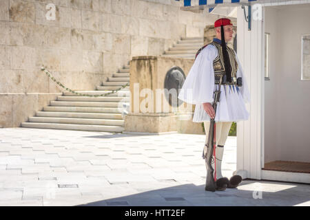 Athens, Greece - March 5, 2017: Evzonas dressed in traditional Greek army uniform (Tsolias) standing guard at the Unknown Soldier Tomp monument Stock Photo