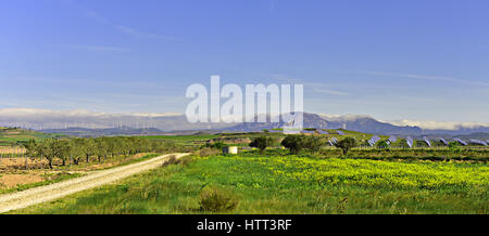 Solar Panels and Windmill Farms with Spanish Cordillera Contabrica - Cantabrian Mountains - seen from the Camino de Santiago de Compostela Stock Photo