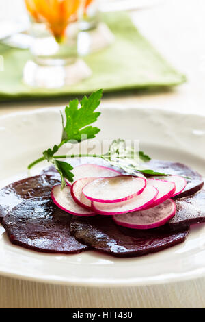 Beetroot radish carpaccio on white plate Stock Photo