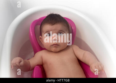 A surprised newborn in her bath. Nice relaxing time.