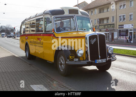 A 1955 Saurer Alpenpostbus L4  CT2D/55 classic vintage bus/coach operated by oldtimerbustouren.de driving in Bielefeld, Germany Stock Photo