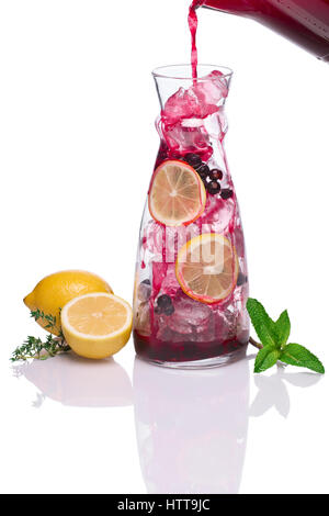 Pouring in jug with ice black currant drink Stock Photo