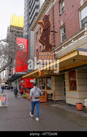 Man walking past the Seattle Coffee Works coffee shop sign  in downtown Seattle, Washington, USA Stock Photo