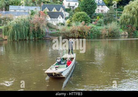 Two passengers being ferried across the River Wye at Symonds Yat Herefordshire Stock Photo