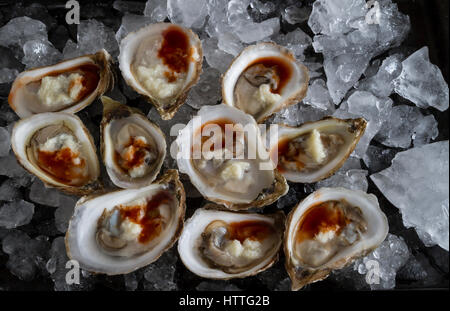 Oysters on the half shell with horseradish and seafood sauce Stock Photo