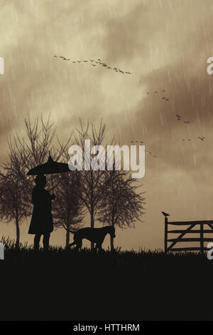 Silhouette of woman walking her dog in the rain Stock Photo